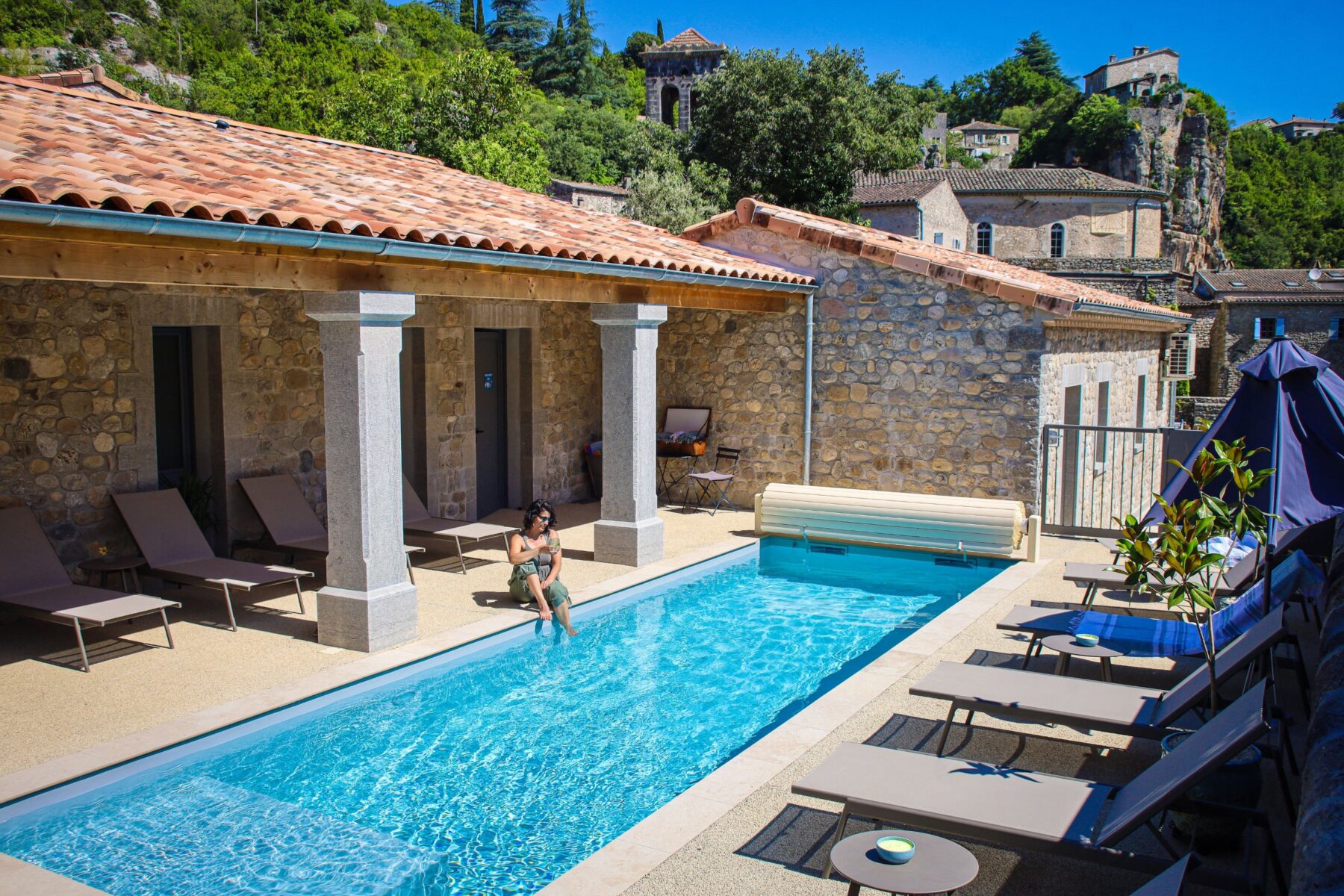 The hotel's heated pool, facing the village — Hôtel La Garenne, Labeaume (Ardèche)